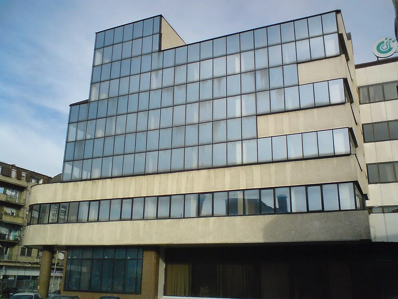 A glass-fronted office building with a Stopanska Banka branch on the ground floor in Bitola
