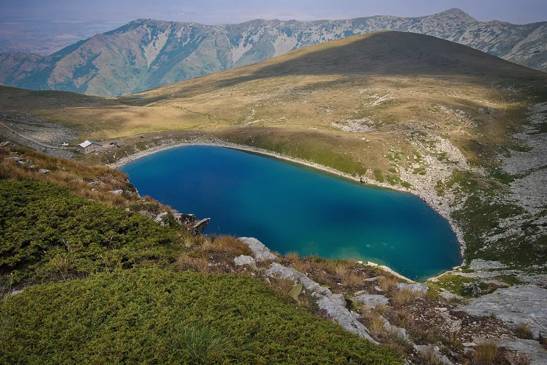 The deep blue Golemo Ezero glacial lake in a rocky cirque high on Pelister