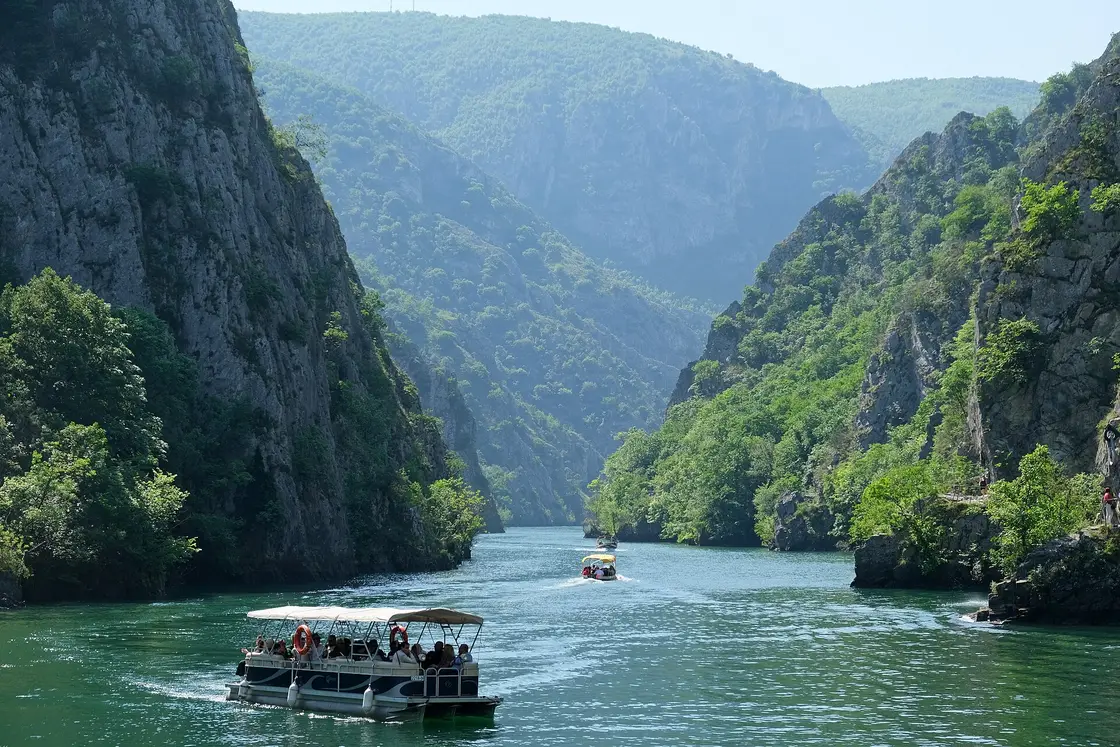 Green reservoir of Matka Canyon winding between wooded cliffs near Skopje