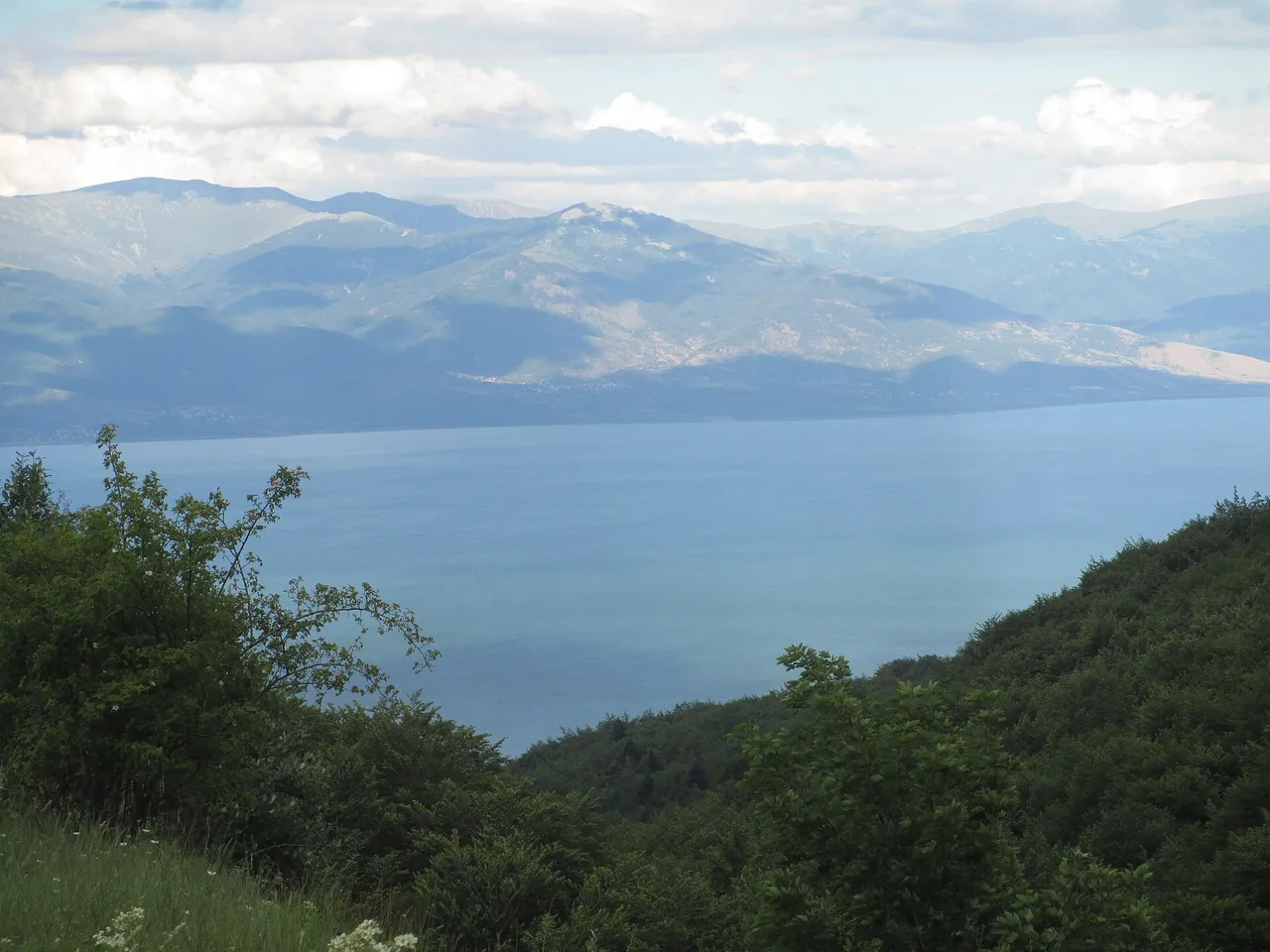 Lake Prespa seen from the heights of Galičica National Park, a wide blue basin under mountains