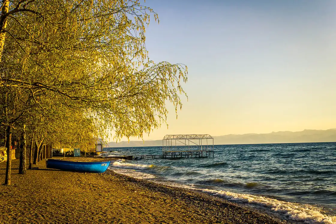 The clear blue water of Lake Ohrid on a bright summer day with the shore beyond