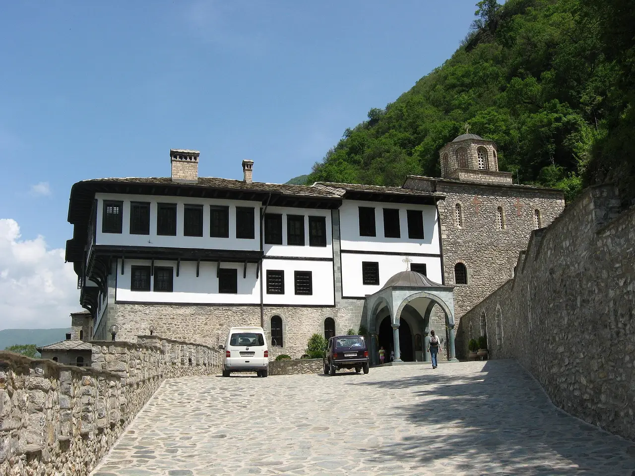 The cobbled approach road leading up to the white monastery buildings and the entrance porch