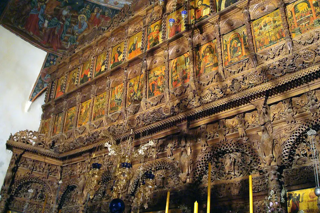The carved walnut iconostasis of Bigorski, dense with figures, foliage and painted icons