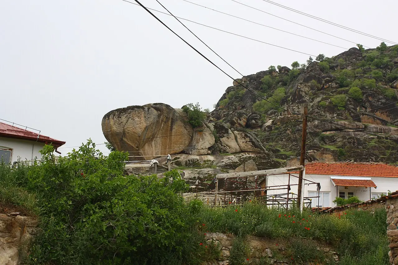Granite boulders of Markovi Kuli rising directly above red-roofed houses on the edge of Prilep