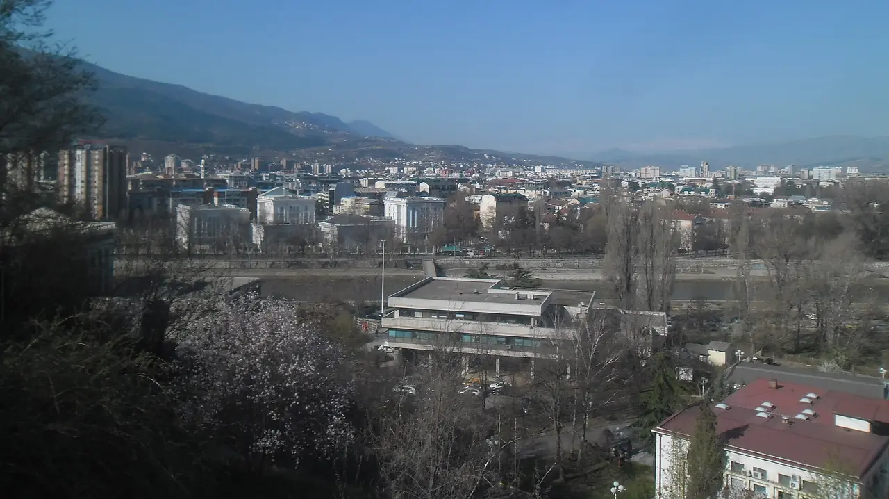 Cityscape of Skopje from the fortress: residential blocks, the Vardar river and mountains beyond