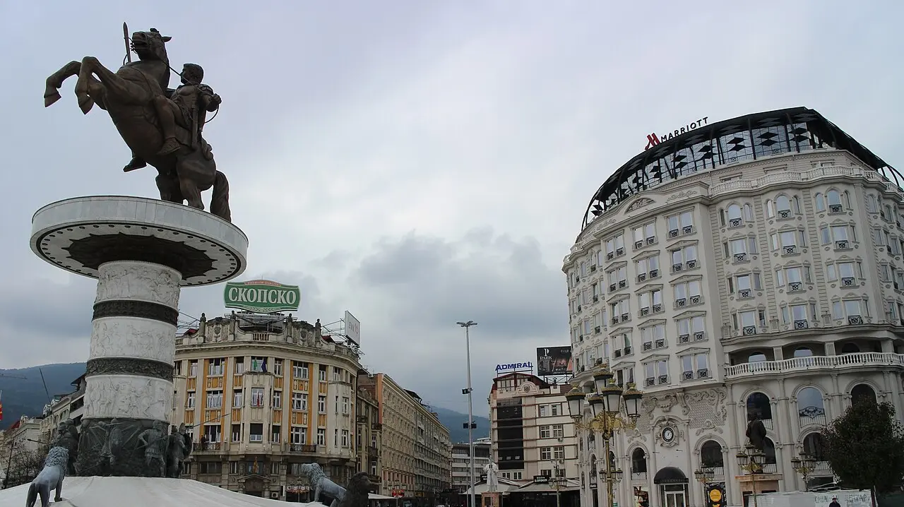 Macedonia Square in central Skopje on a clear day, with statues and the city rising behind