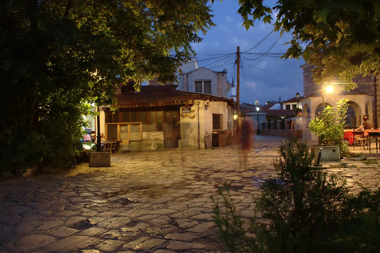A lane in Skopje Old Bazaar with shops and people walking between timber-framed buildings