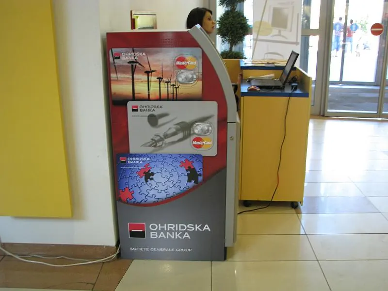 An Ohridska Banka ATM built into a stone wall on a street in Ohrid
