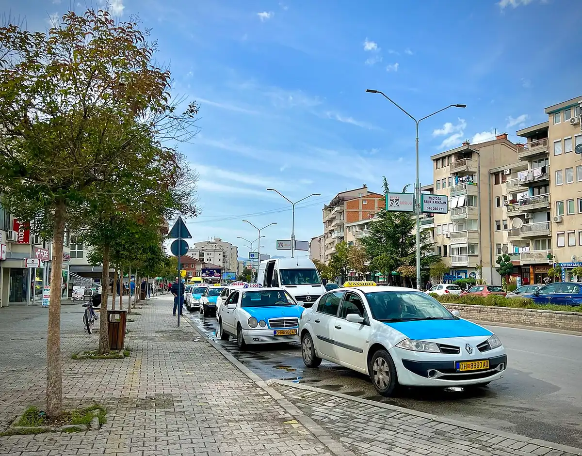 Yellow taxis parked at a stand on a street in Ohrid