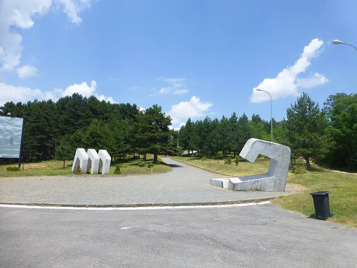 White dome of the Makedonium Ilinden monument above pines in Kruševo