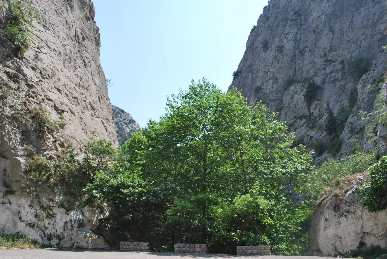 Steep limestone cliffs of the Demir Kapija gorge above the Vardar river and road
