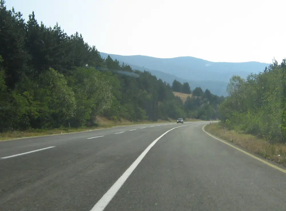A two-lane national road through wooded hills in North Macedonia
