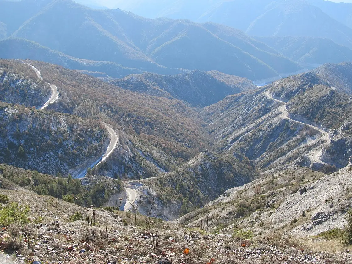 A quiet rural road winding through the hills of North Macedonia