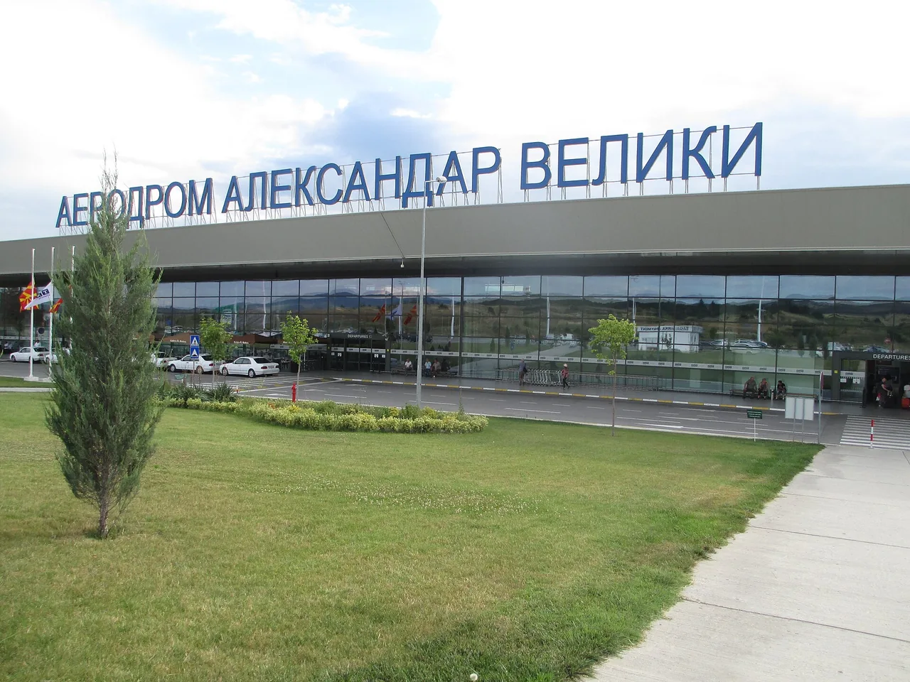 Exterior of Skopje International Airport terminal under a clear sky