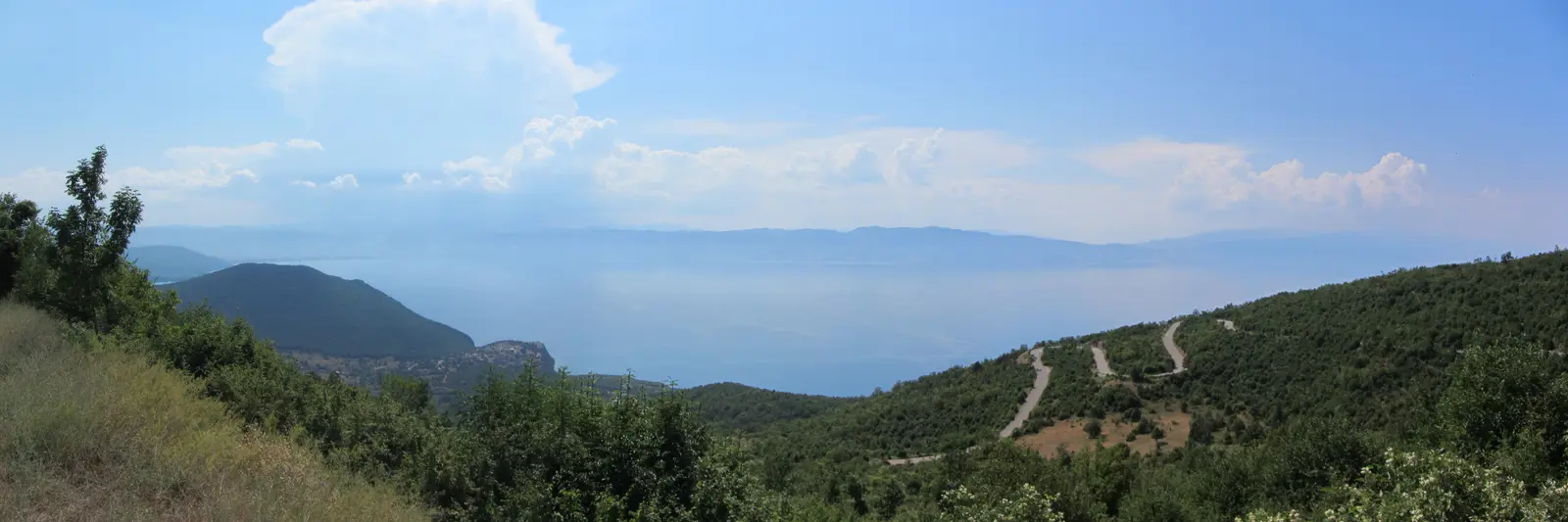 A road curving above the blue water of Lake Ohrid in Galičica National Park