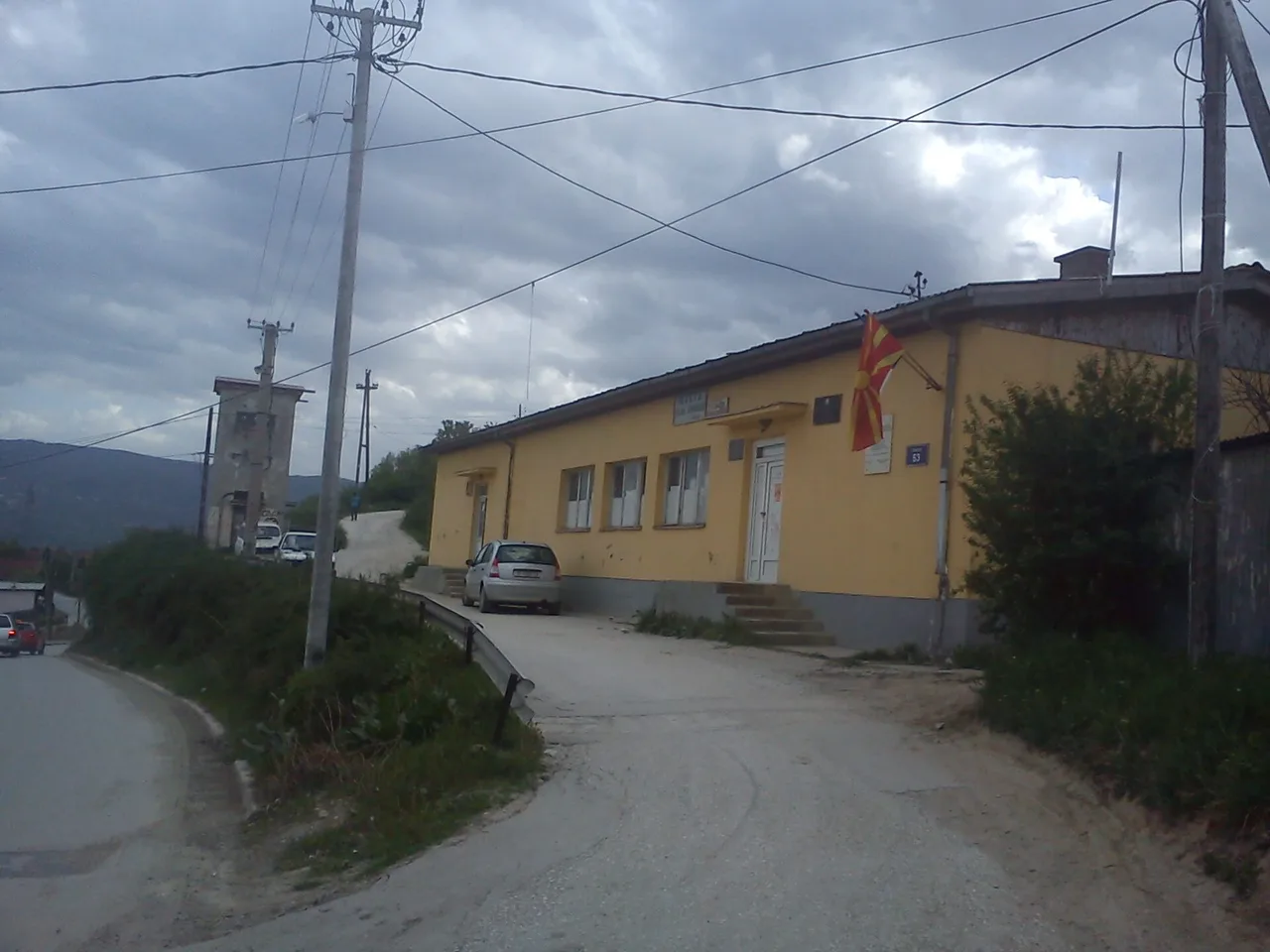 Small yellow single-storey building housing the local community office and health clinic in Volkovo near Skopje