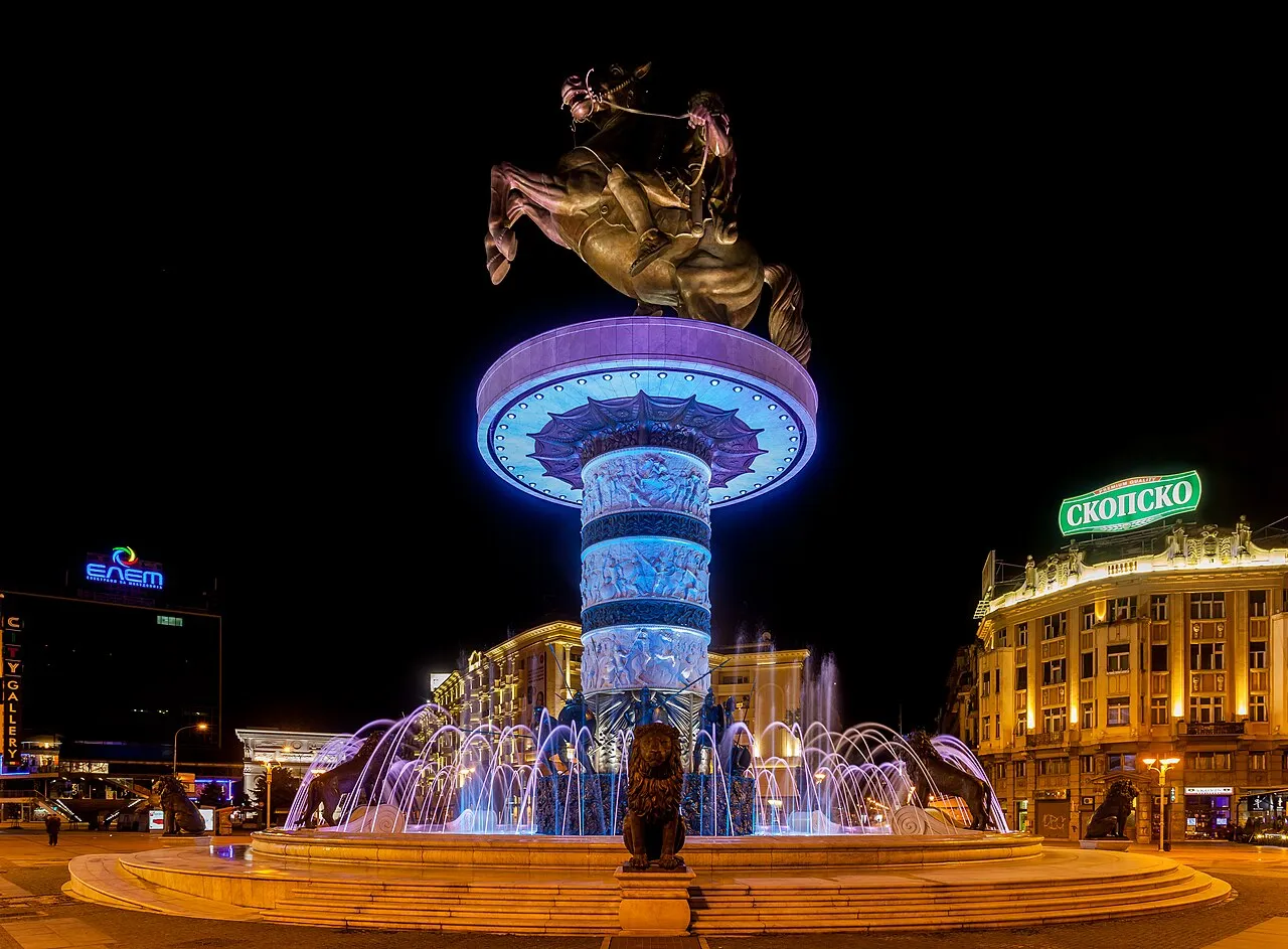 The floodlit Warrior on a Horse statue and fountain on Macedonia Square in Skopje at night