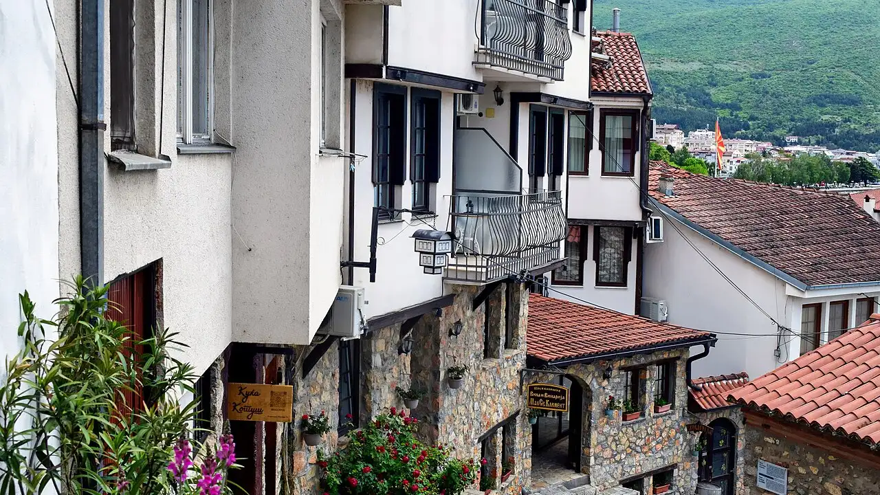 The stone-and-timber old town of Ohrid climbing the hillside above the calm blue water of Lake Ohrid