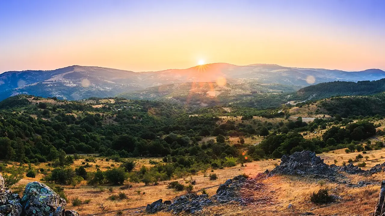 Low sun over the rocky crest of Kokino with the hills of north-east North Macedonia stretching to the horizon