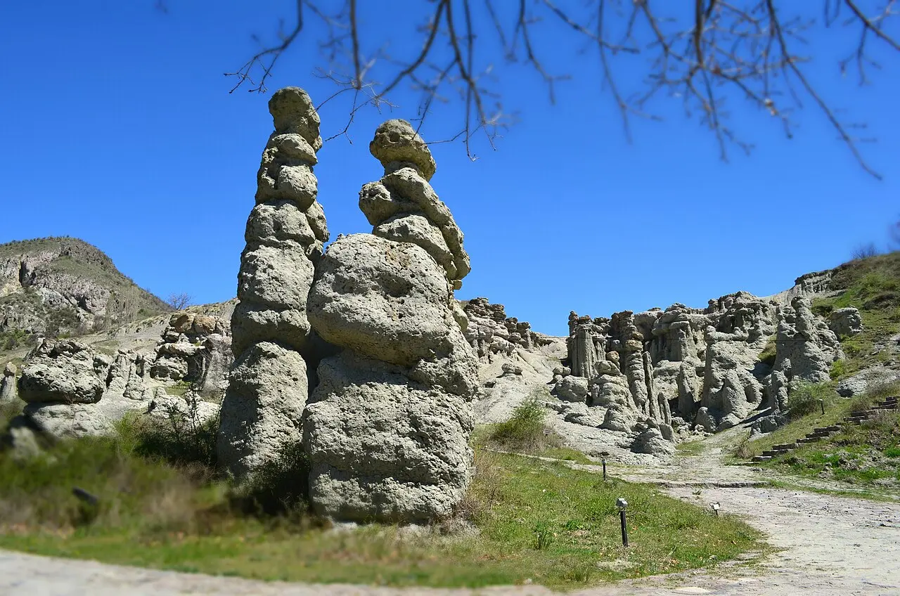 A tall pair of stone pillars at Kuklica known locally as the bride and groom, with more pillars behind