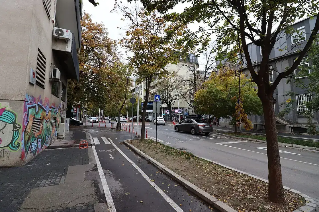 Low-rise street in Debar Maalo, Skopje, with parked cars and apartment facades