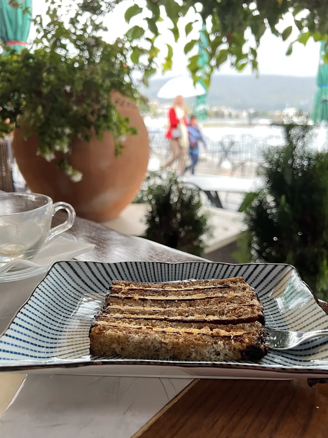 Slice of Gerbeaud cake on a plate with a Cyrillic dessert label in Ohrid