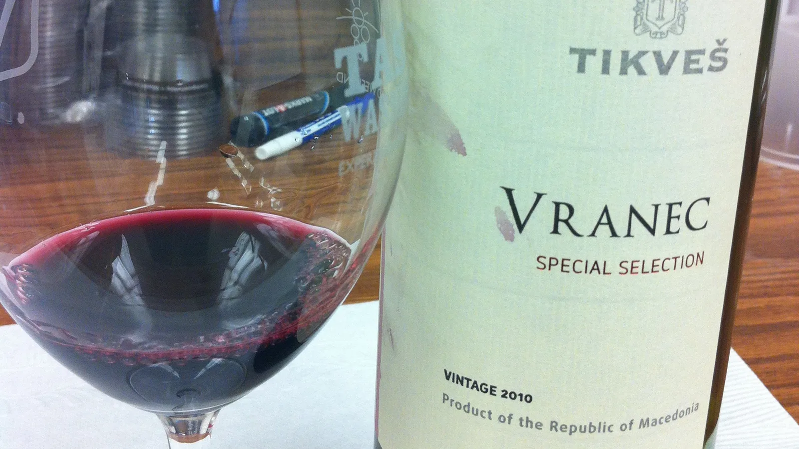 A glass of red wine beside a bottle of Tikveš Vranec Special Selection