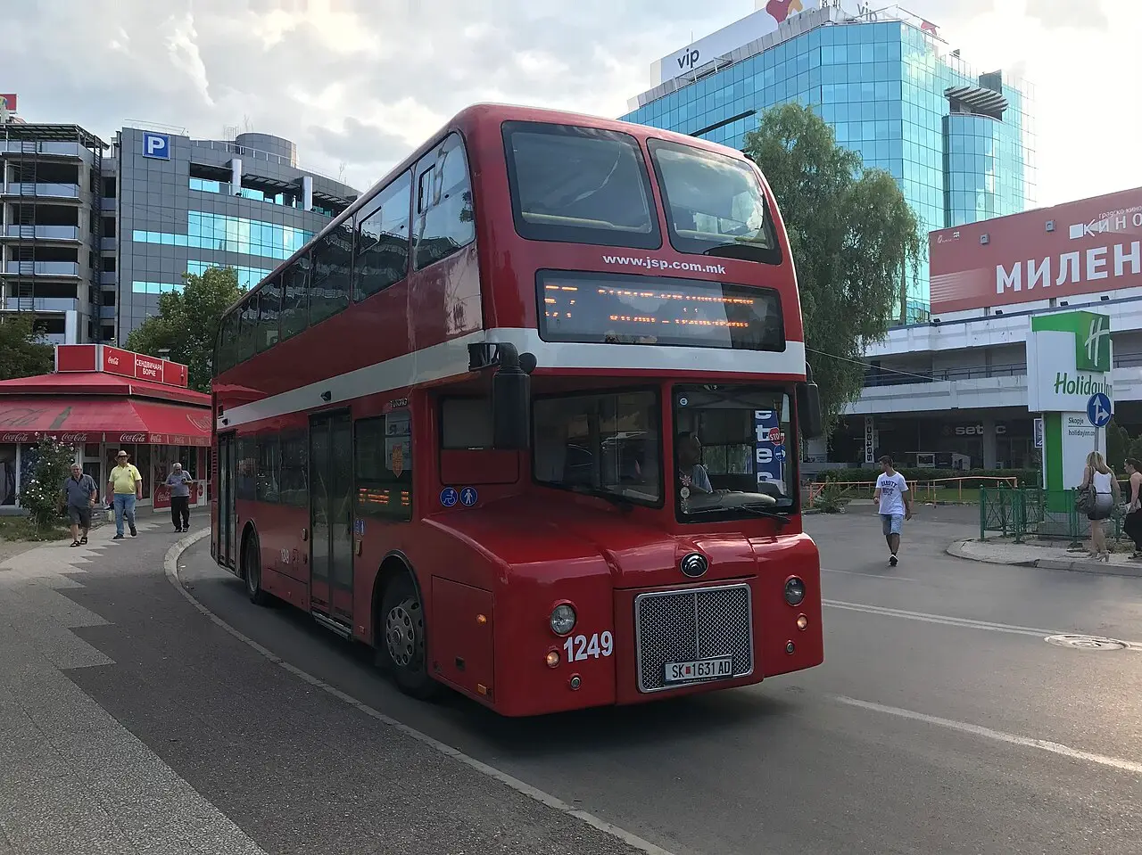 A red double-decker JSP Skopje city bus at a stop in central Skopje