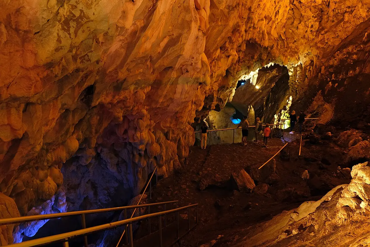 Lit interior of the Vrelo cave at Matka with walkways and stalactites