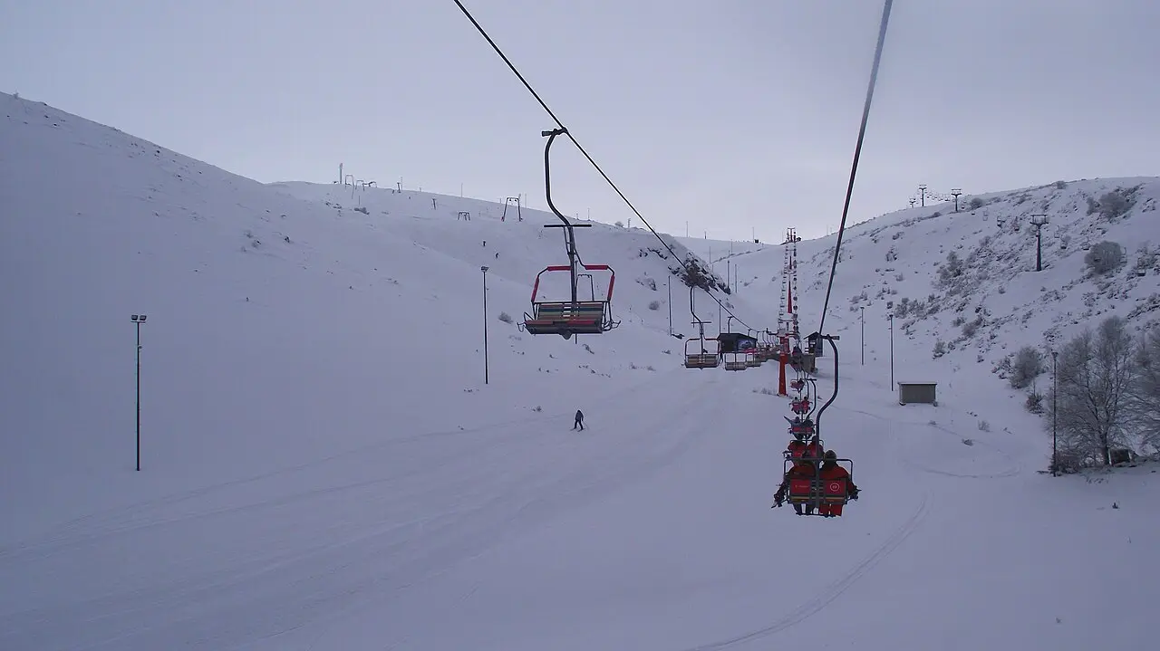 View from a chairlift at Mavrovo over the snowy piste with empty chairs ahead