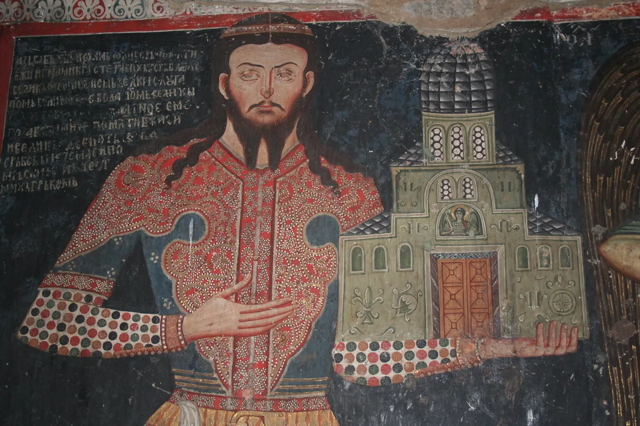 Fresco of Jovan Oliver at Lesnovo, a bearded man in a red and gold robe holding a green model of the domed church