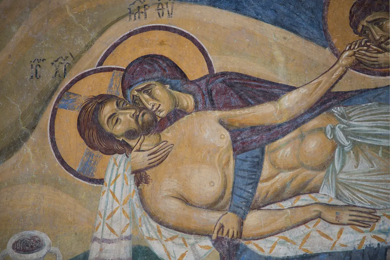 Fresco detail from Nerezi showing Mary pressing her cheek to the face of the dead Christ while a disciple kisses his hand
