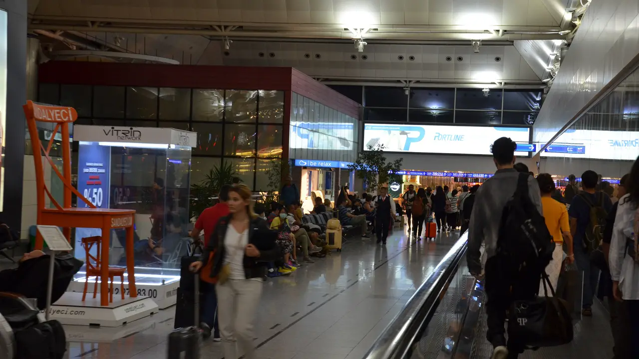 Passengers in the arrivals hall at Skopje International Airport after landing in North Macedonia