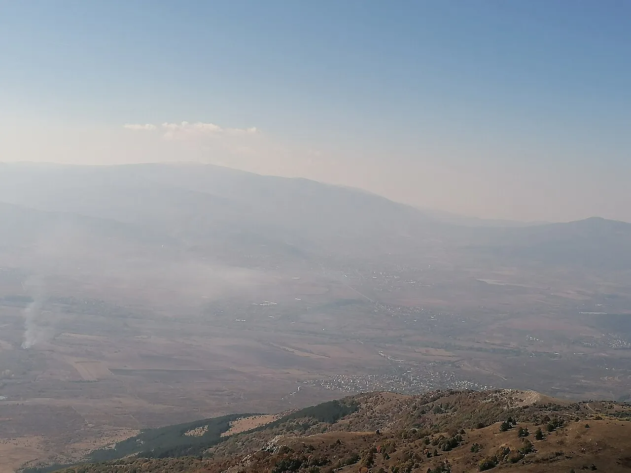 A hazy view over a valley and mountains from Mount Viden, near the Deve Bair pass into Bulgaria