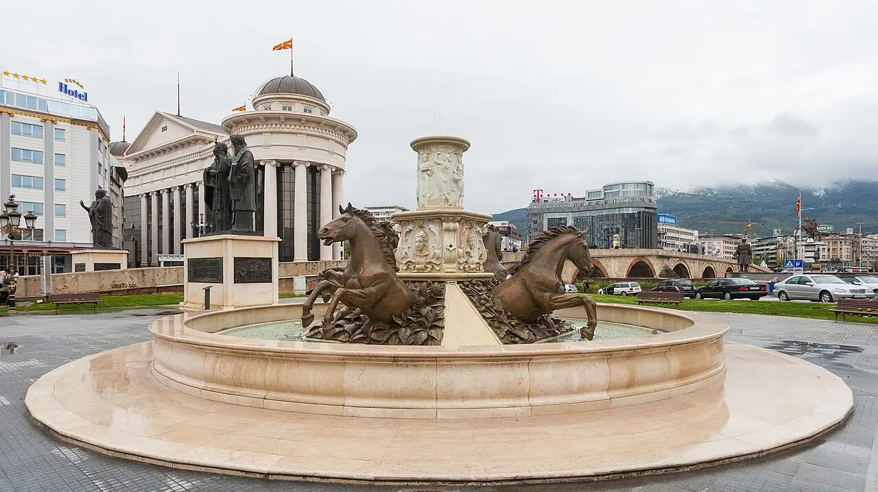 The fountain and modern facades of Macedonia Square in central Skopje on a clear day
