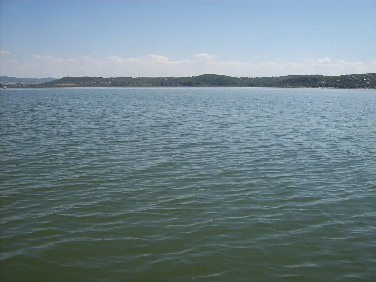 Lake Dojran seen from the Macedonian shore, with the low hills of the far side across the water