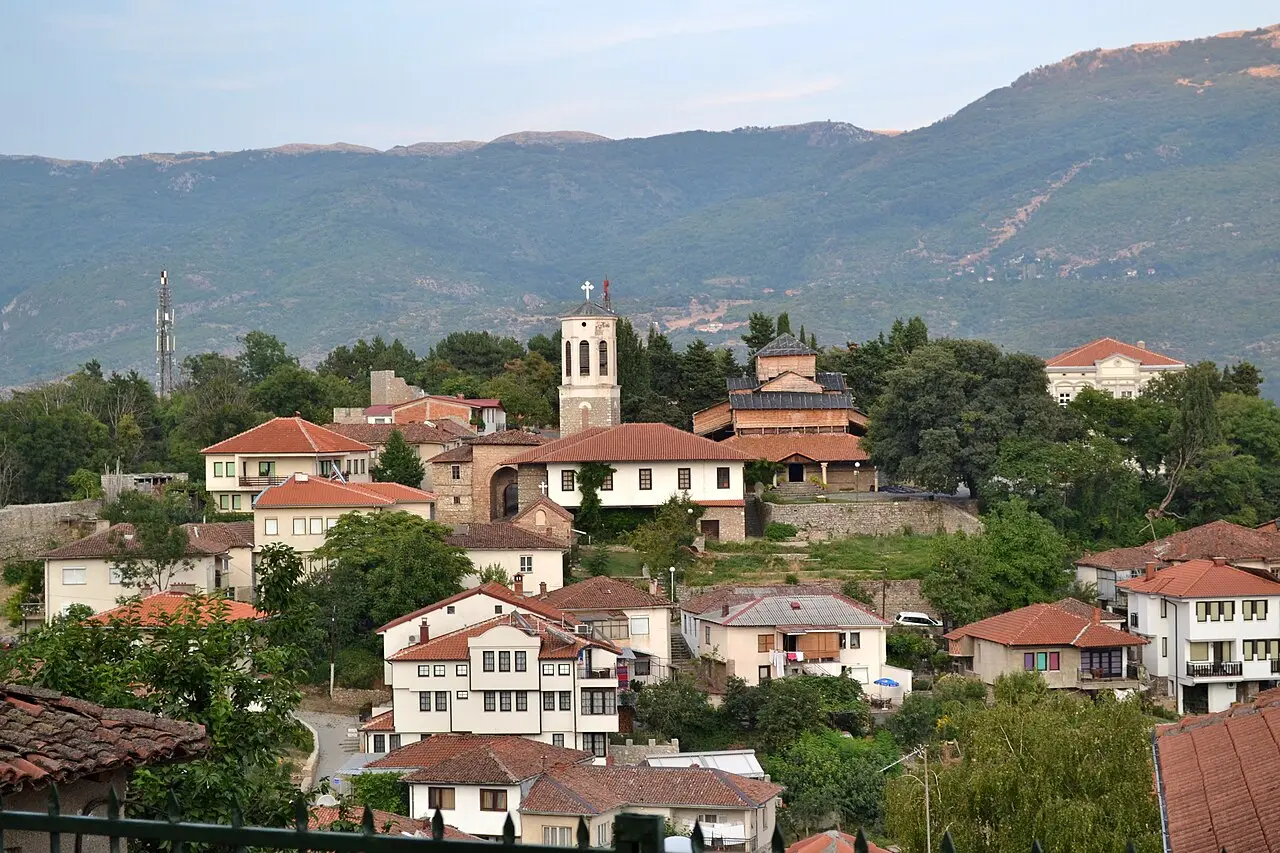 The red-roofed old town of Ohrid stepping down to the blue lake with mountains beyond
