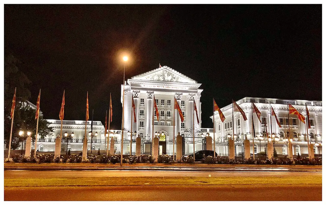 North Macedonia government building exterior with flags on a sunny day