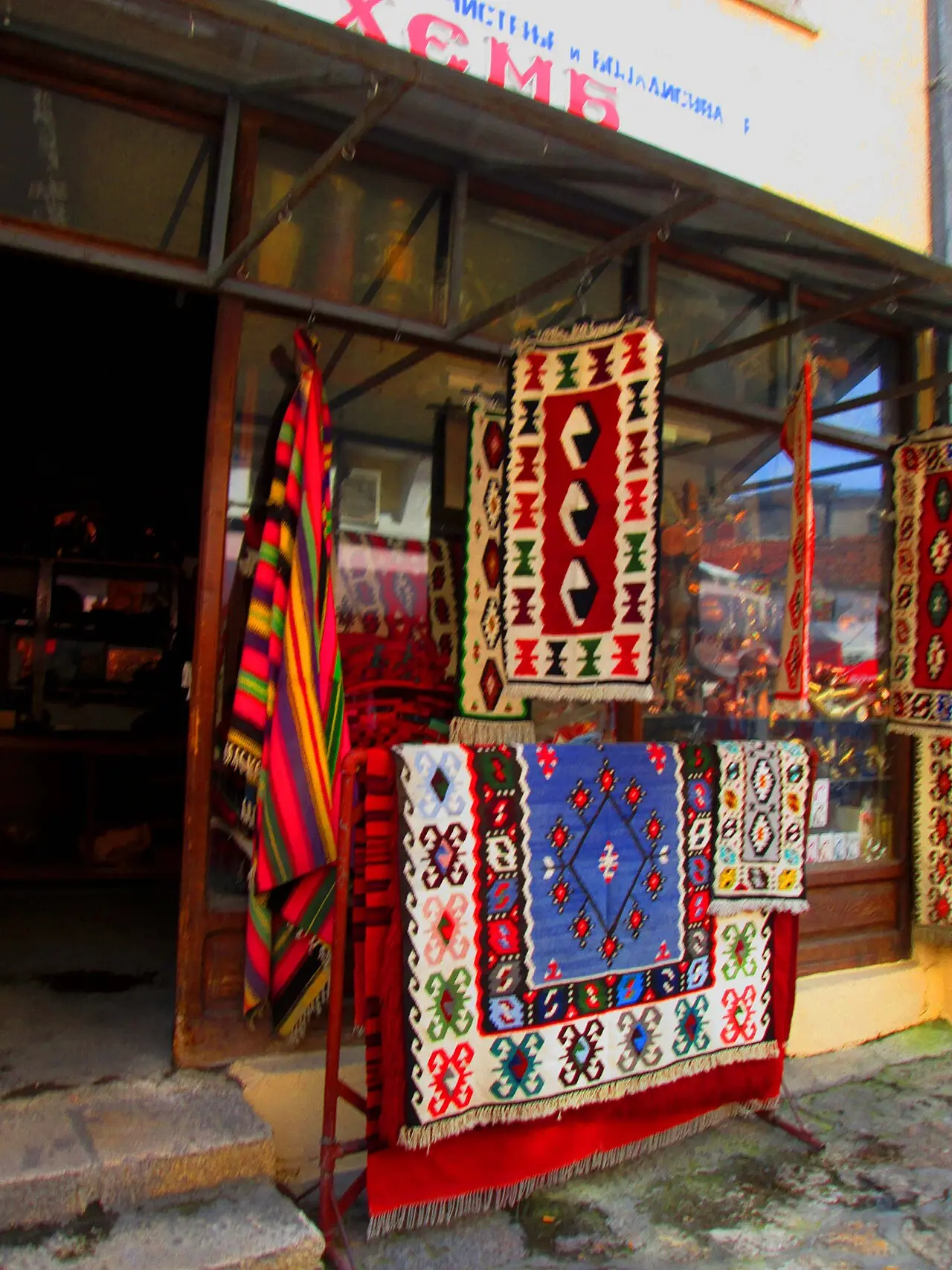 Stacks of colourful woven rugs for sale in Skopje Old Bazaar