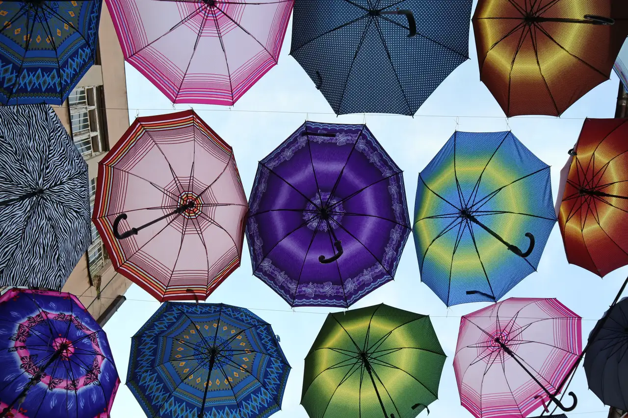 A canopy of brightly coloured open umbrellas strung above a lane in Skopje's Old Bazaar