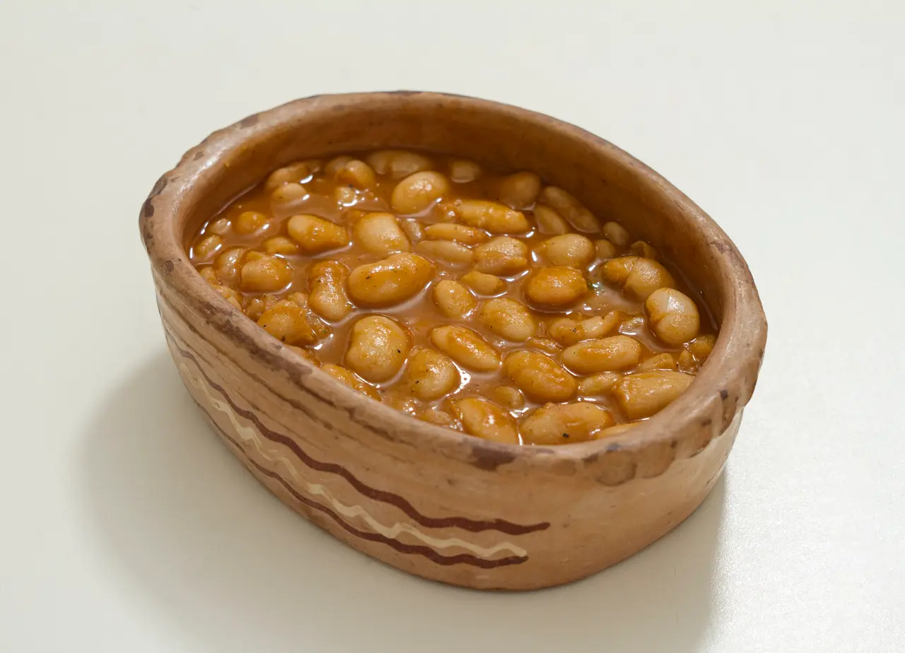 Tavče gravče, baked white beans in a red sauce, served in a traditional earthenware pot