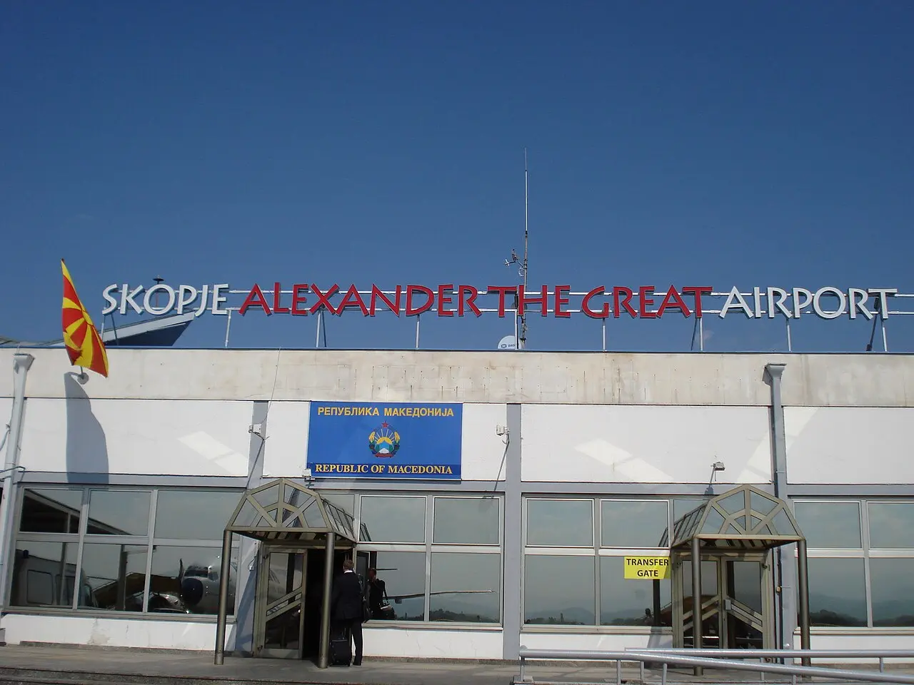 The terminal building of Skopje International Airport under a blue sky