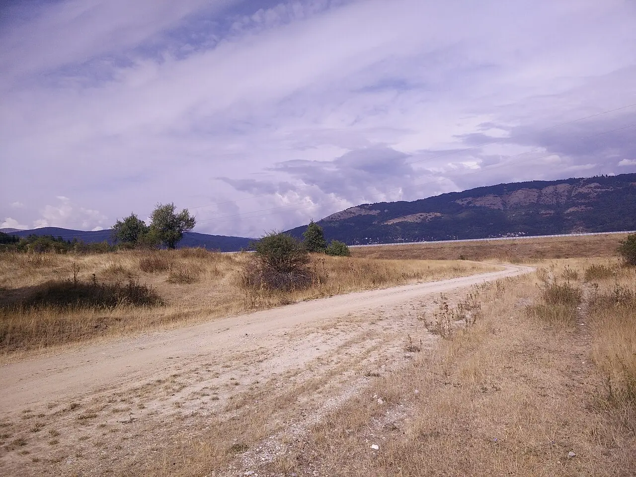 Forested slopes and still water in Mavrovo National Park, North Macedonia