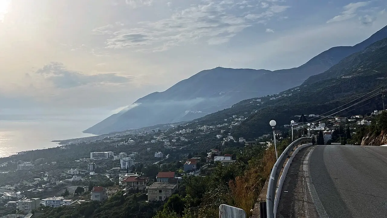 The steep coastline and clear blue water of Dhërmi on the Albanian Riviera