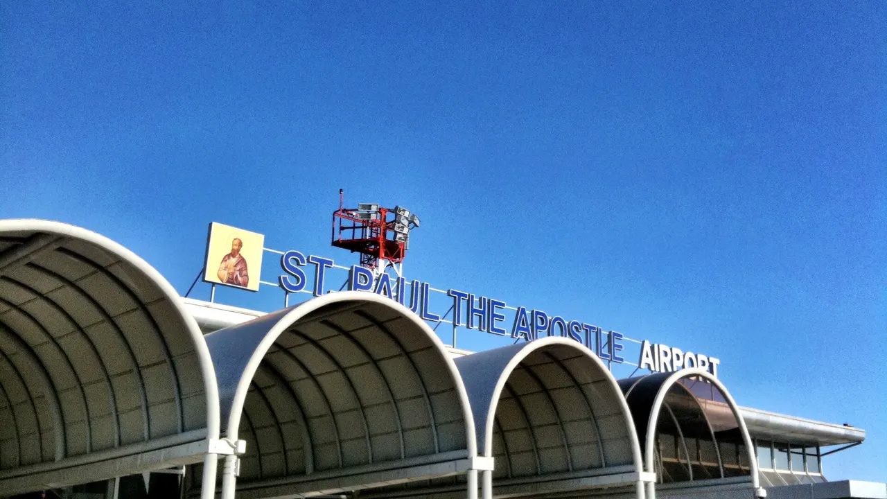 The arched entrance and rooftop sign of St. Paul the Apostle Airport at Ohrid