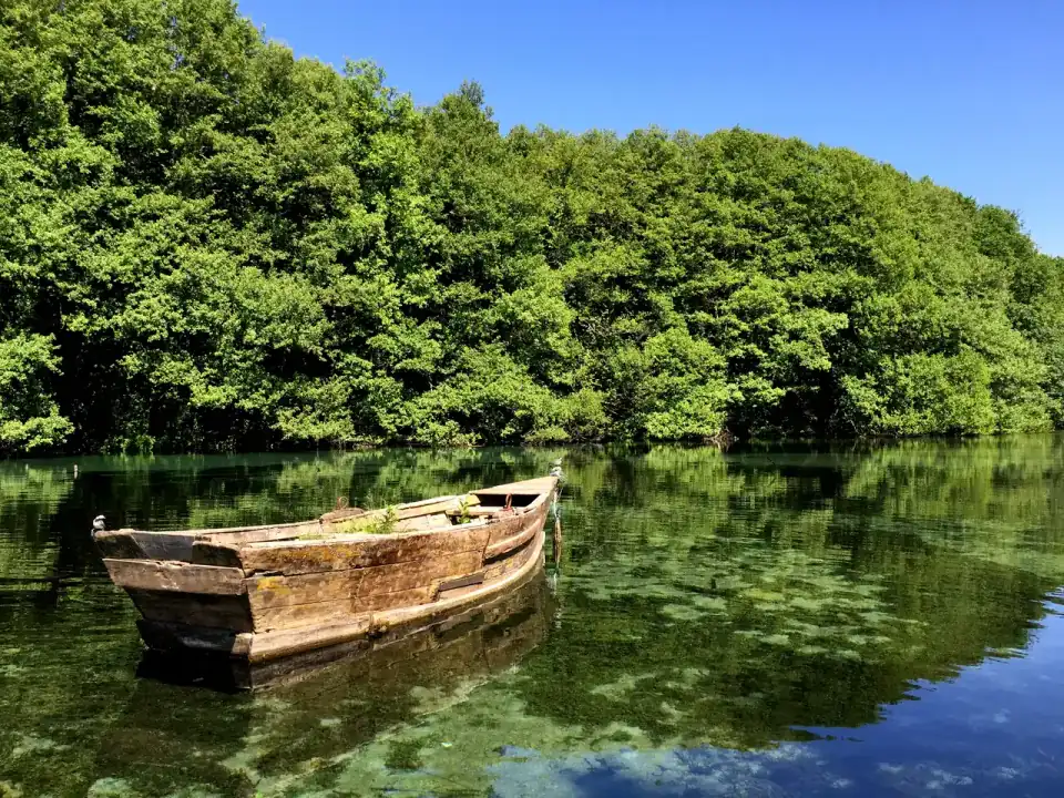 A small rowing boat on the clear Black Drim springs at St. Naum