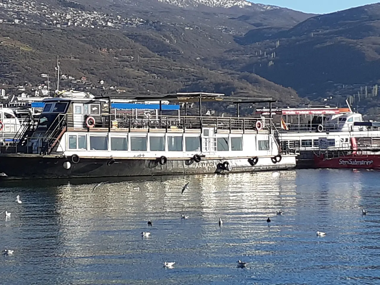 Excursion boats moored at Ohrid harbour on a clear winter day