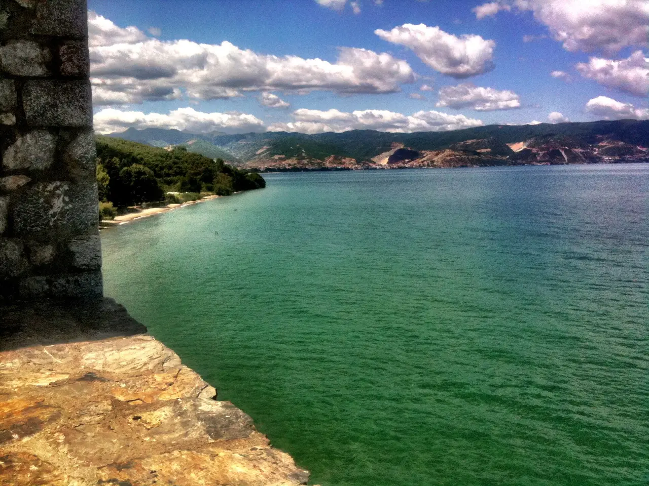 Turquoise water of Lake Ohrid seen from Sveti Naum, with the Albanian shore and Pogradec in the distance