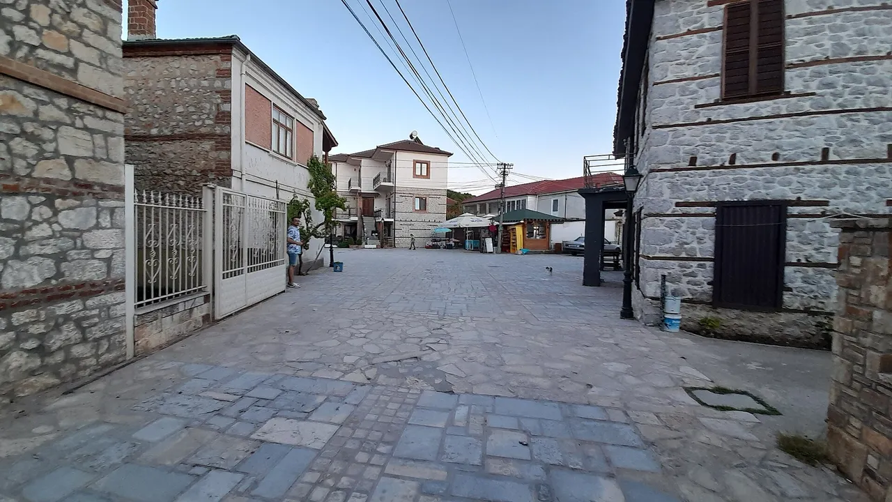 A quiet stone-paved square in the Albanian village of Tushemisht near Pogradec
