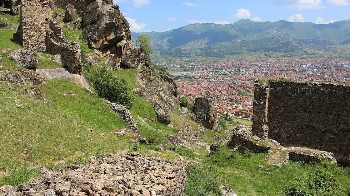 The ruined ramparts of Markovi Kuli fortress among granite boulders above Prilep, with the Pelagonia plain and mountains below